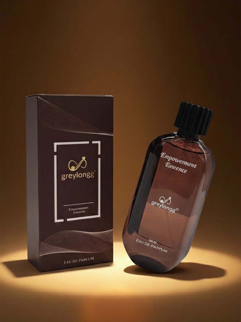 Greylongg Empowerment Essence eau de parfum bottle and box under warm light