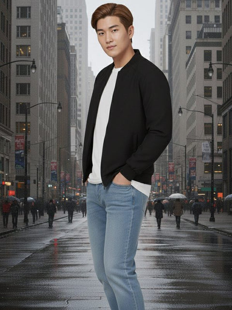 Man in a black bomber jacket on a city street